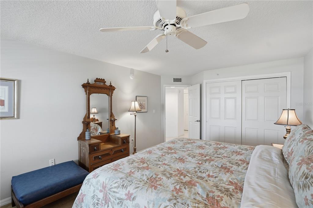 16326 Gulf Boulevard, Unit 307 Redington Beach, FL 33708 - Photo 23 of 43 a bedroom with a bed and a chair
