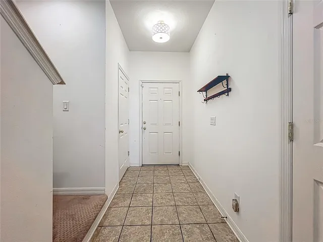 a view of kitchen with granite countertop cabinets and window