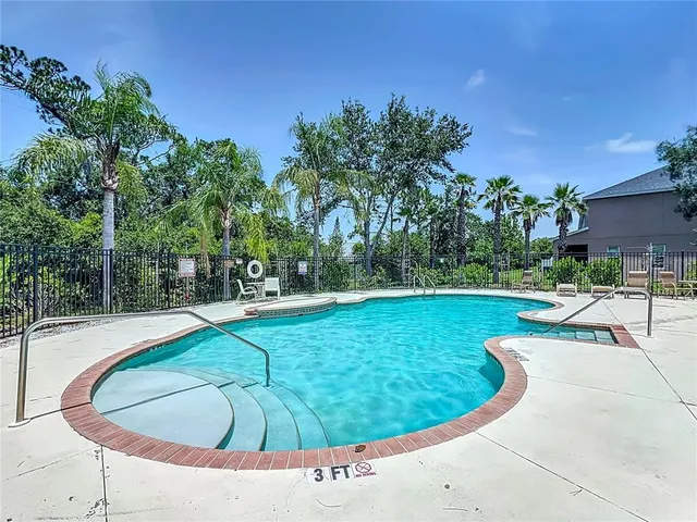 a view of a swimming pool with a outdoor seating