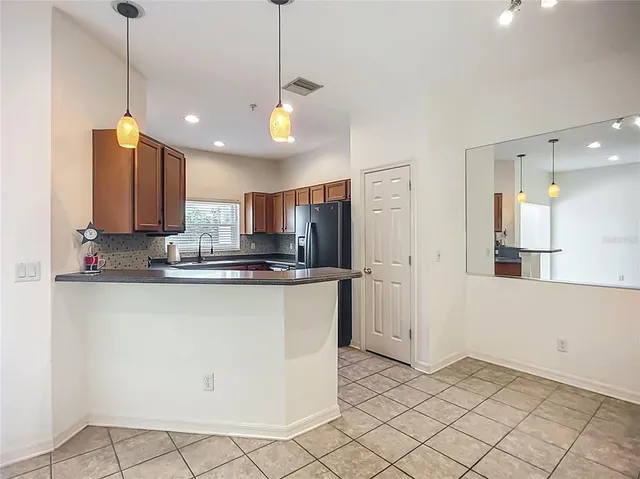 a view of a kitchen with marble kitchen and stainless steel appliances