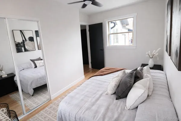 a bedroom with a bed a couch and a window