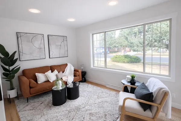 a living room with furniture and a large window