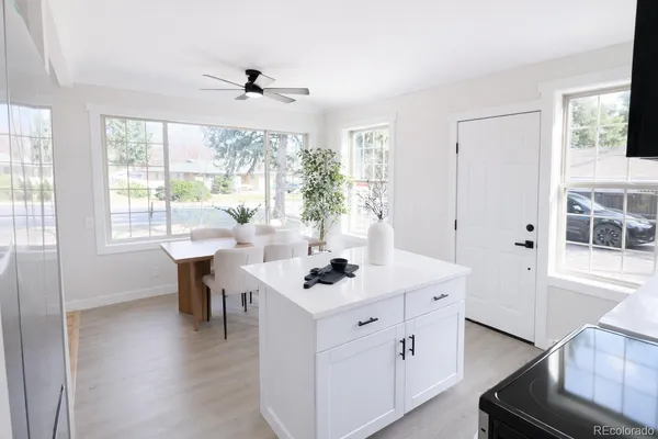 a white table sitting in a living room next to a window