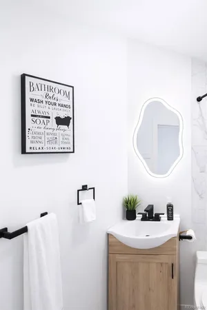 a bathroom with a sink mirror and vanity