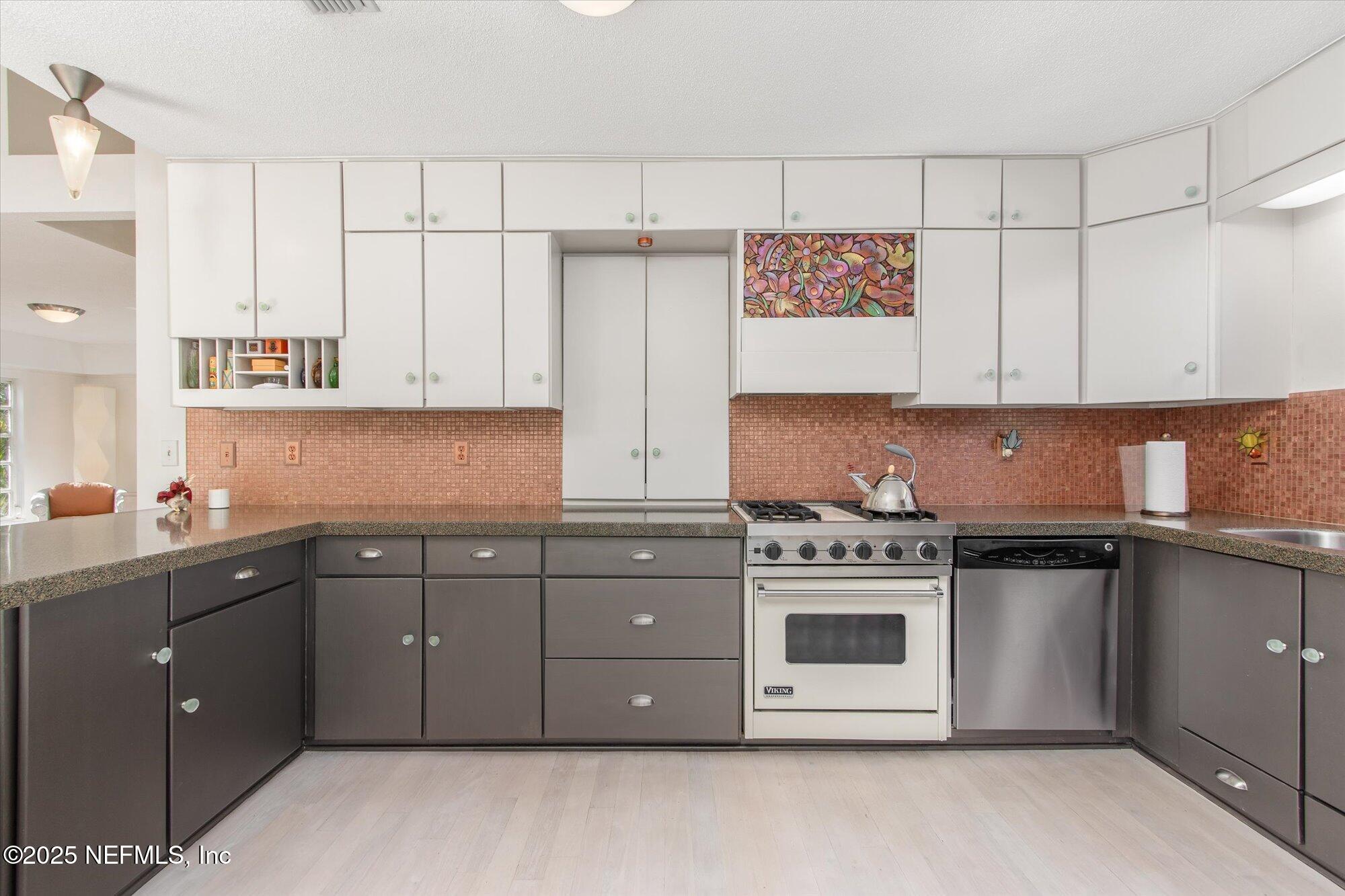 1685 Santander Street St. Augustine, FL 32080 - Photo 11 of 48 a kitchen with stainless steel appliances granite countertop a stove and a white cabinets