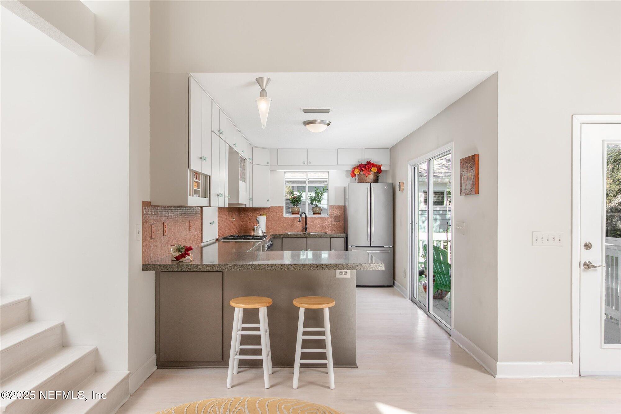 1685 Santander Street St. Augustine, FL 32080 - Photo 12 of 48 a kitchen with kitchen island cabinets and refrigerator