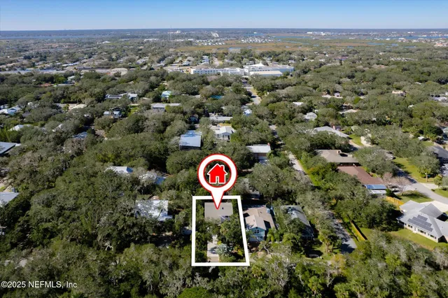 an aerial view of residential house with outdoor space and trees
