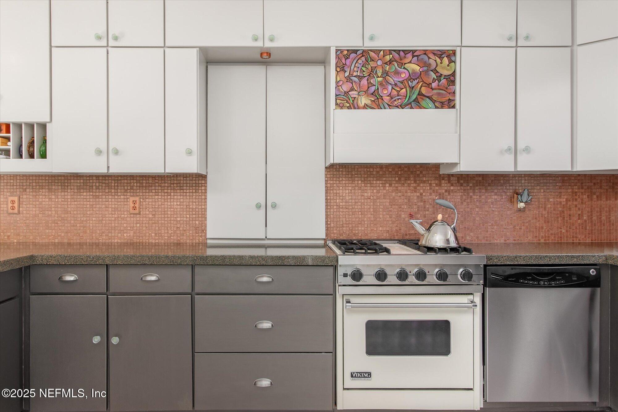 1685 Santander Street St. Augustine, FL 32080 - Photo 10 of 48 a kitchen with granite countertop cabinets stainless steel appliances and wooden floor