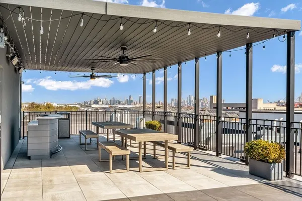 a terrace with outdoor seating and city view