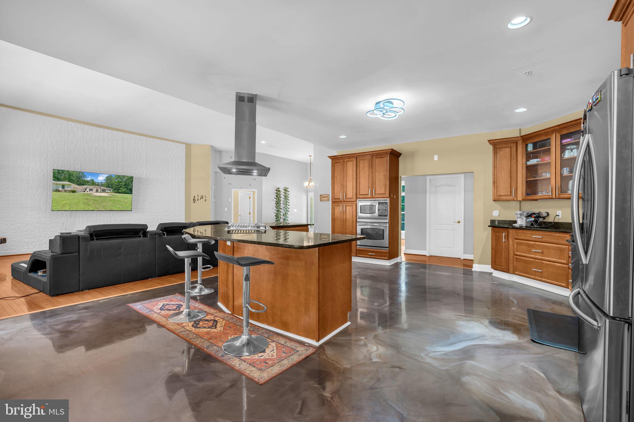 13716 Molly Berry Road Brandywine, MD 20613 - Photo 11 of 75 a living room with furniture a large window and stainless steel appliances