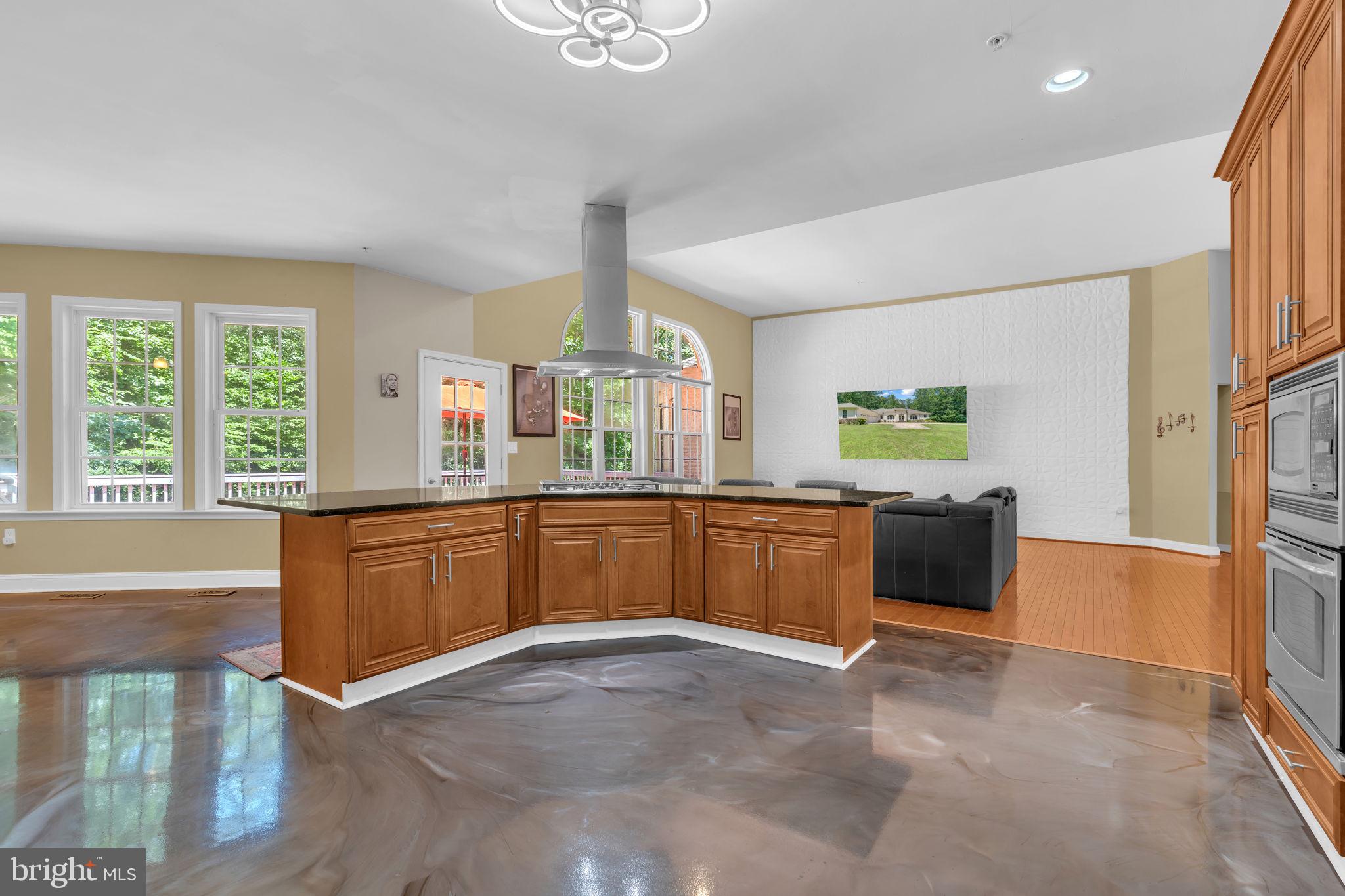 13716 Molly Berry Road Brandywine, MD 20613 - Photo 12 of 75 a kitchen with stainless steel appliances kitchen island wooden cabinets a refrigerator and a sink