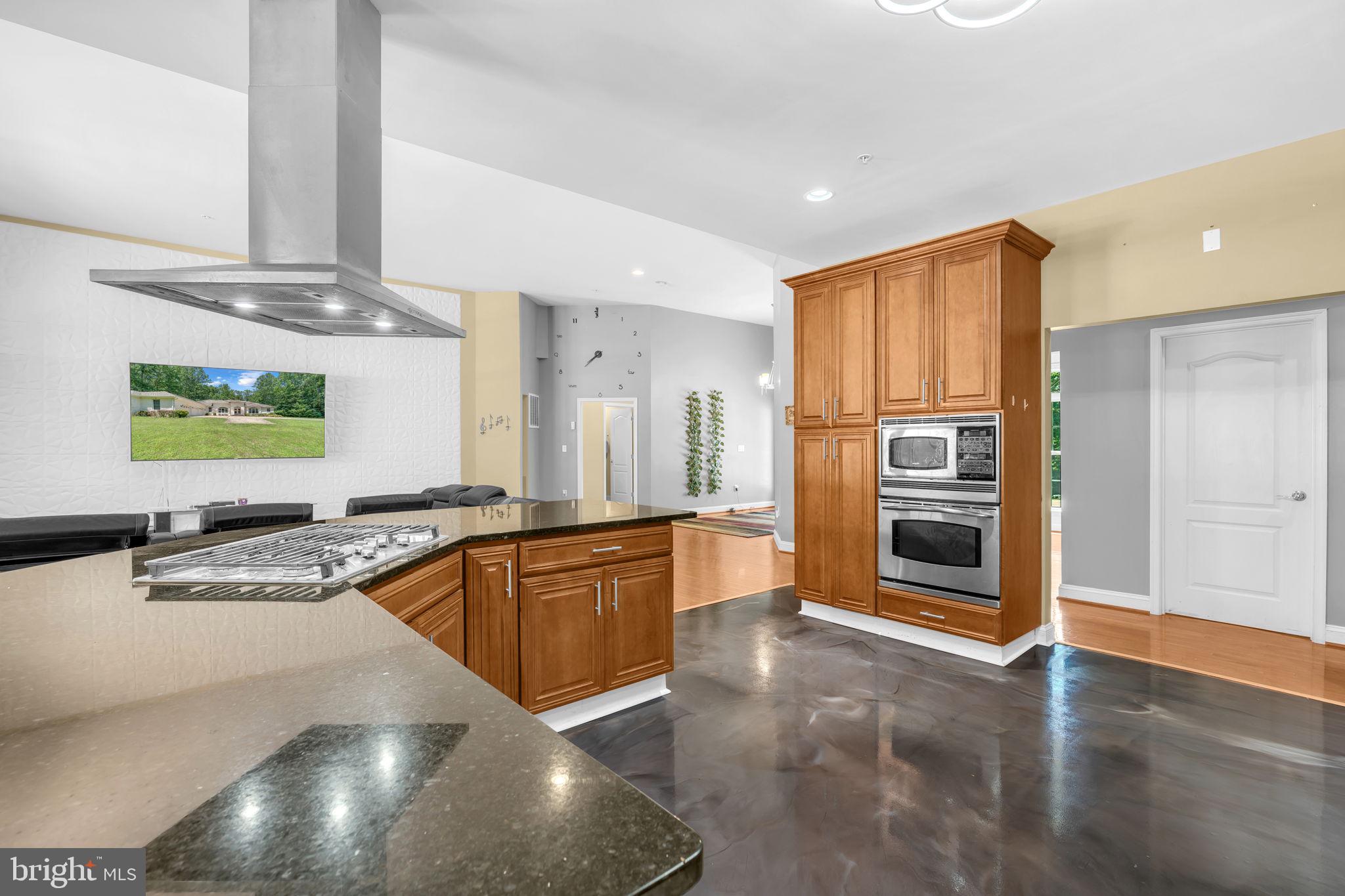 13716 Molly Berry Road Brandywine, MD 20613 - Photo 15 of 75 a large kitchen with stainless steel appliances a large counter top a stove and a refrigerator