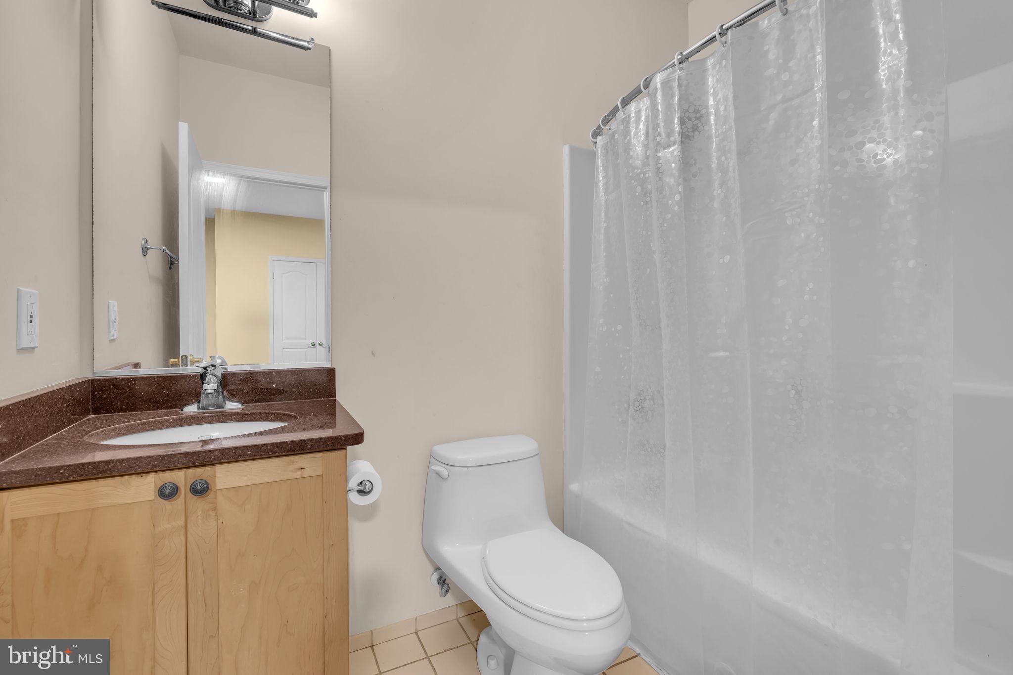 13716 Molly Berry Road Brandywine, MD 20613 - Photo 24 of 75 a bathroom with a granite countertop sink toilet and a mirror