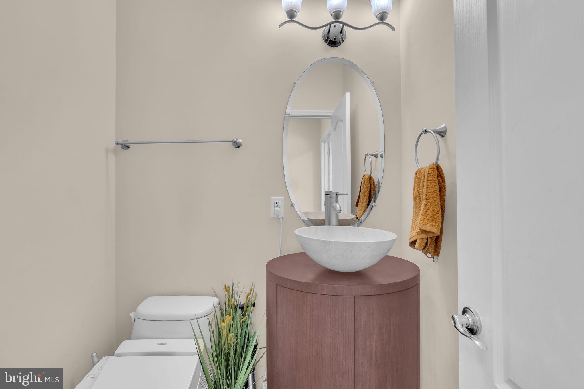 13716 Molly Berry Road Brandywine, MD 20613 - Photo 31 of 75 a bathroom with a toilet a sink and mirror