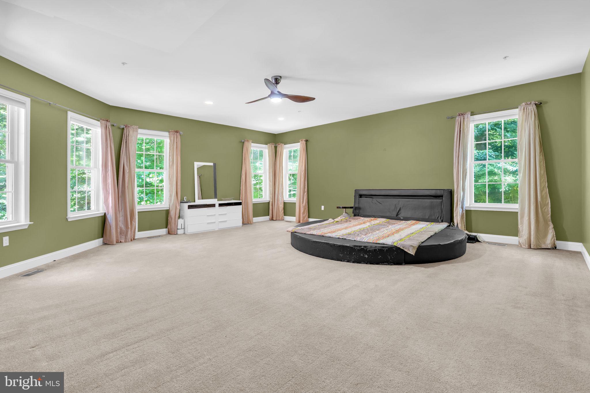 13716 Molly Berry Road Brandywine, MD 20613 - Photo 32 of 75 a spacious bedroom with a large bed and a large window