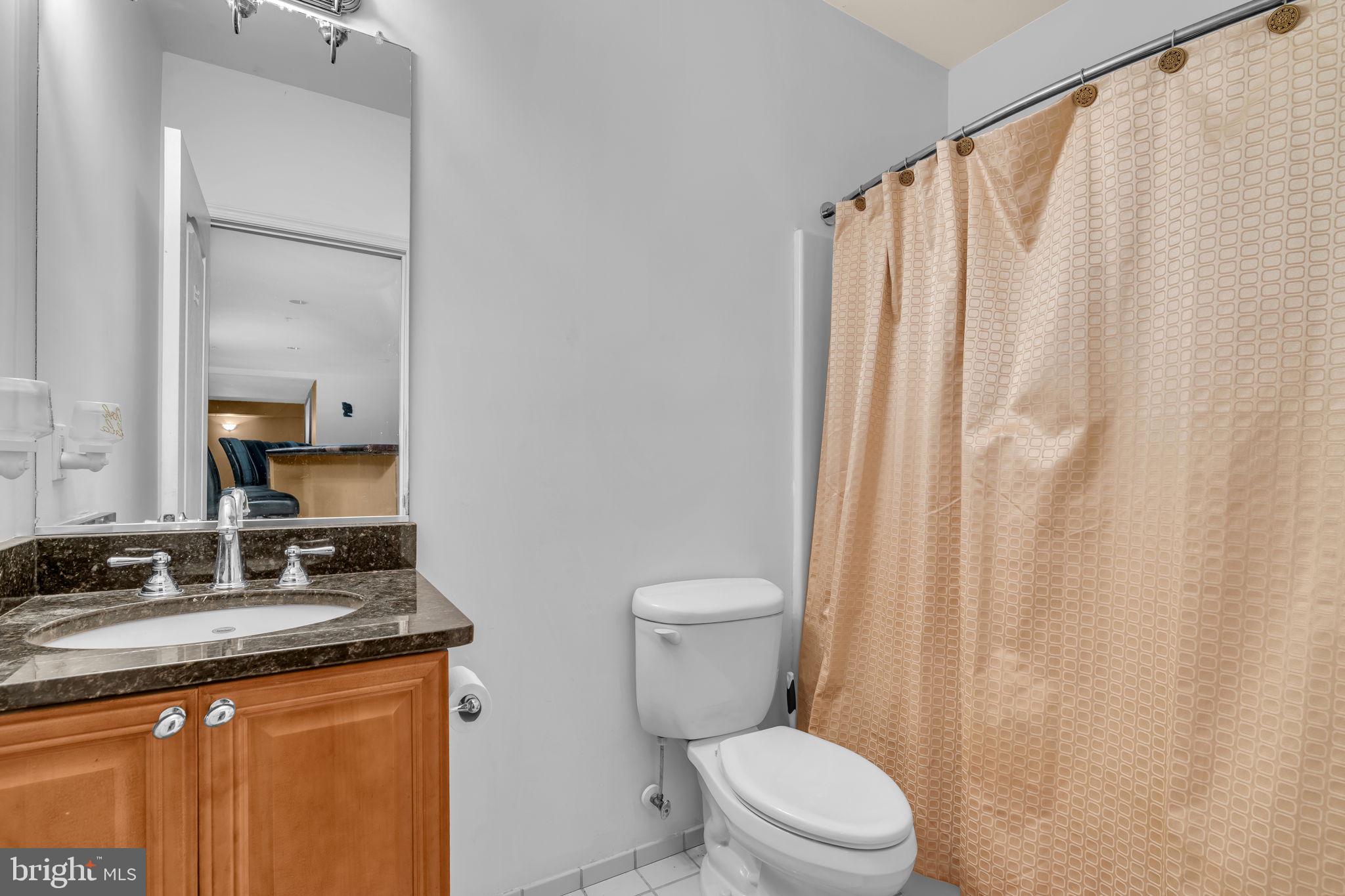 13716 Molly Berry Road Brandywine, MD 20613 - Photo 51 of 75 a bathroom with a granite countertop sink toilet and a mirror