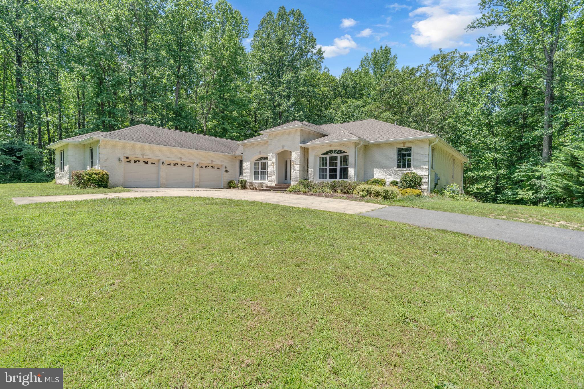 13716 Molly Berry Road Brandywine, MD 20613 - Photo 61 of 75 a front view of a house with a garden and trees