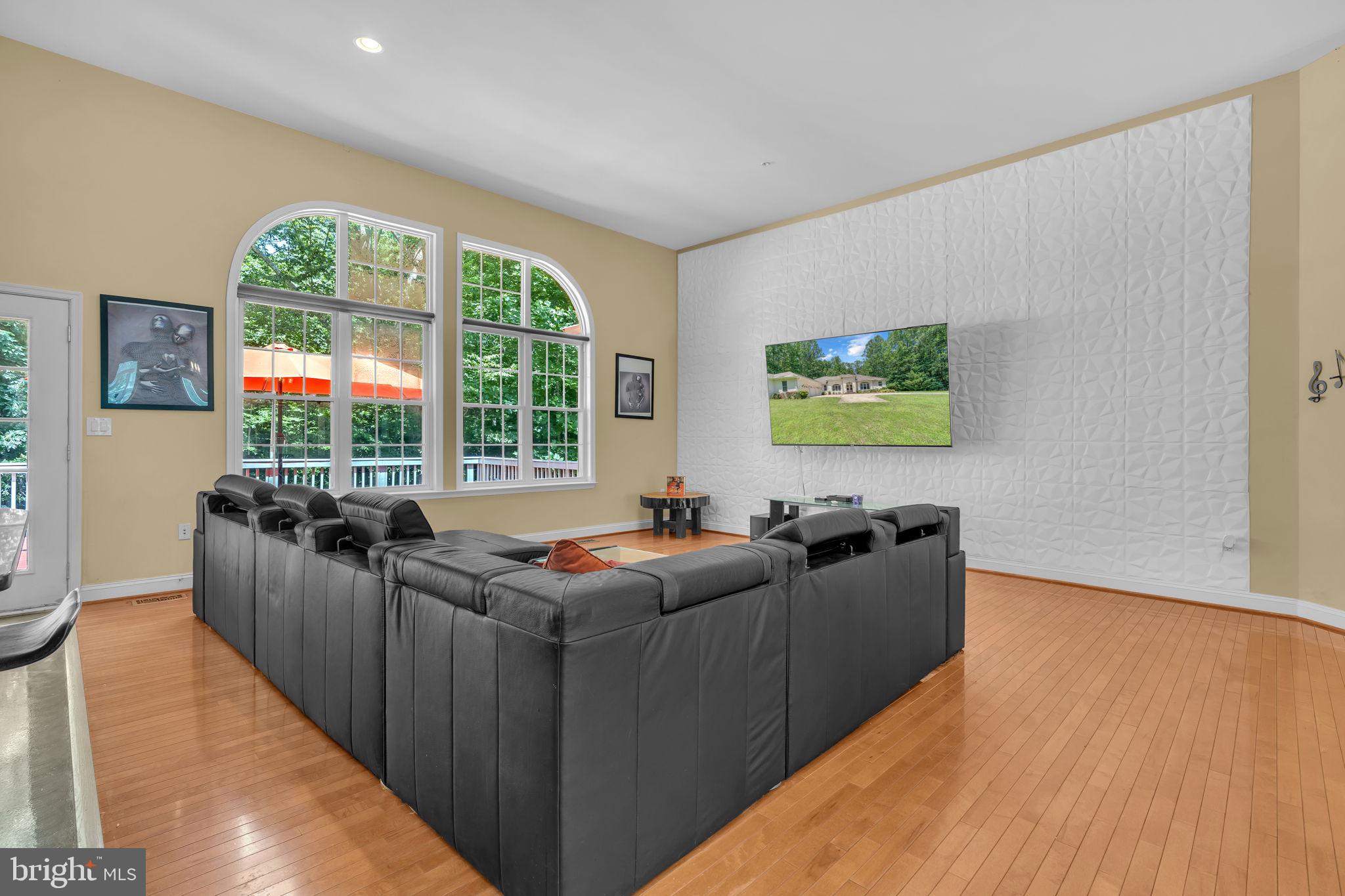 13716 Molly Berry Road Brandywine, MD 20613 - Photo 8 of 75 a living room with furniture a flat screen tv and a large window