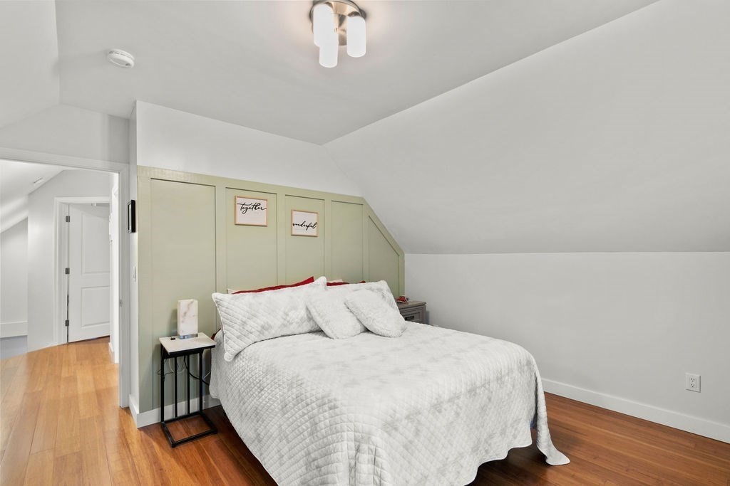 466 Rounseville Road Rochester, MA 02770 - Photo 16 of 38 a bedroom with a bed and wooden floor
