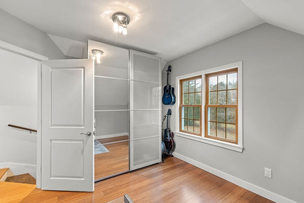 466 Rounseville Road Rochester, MA 02770 - Photo 20 of 38 a view of an empty room with a window and wooden floor
