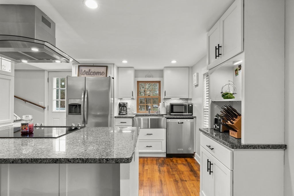 466 Rounseville Road Rochester, MA 02770 - Photo 10 of 38 a kitchen with stainless steel appliances granite countertop a sink refrigerator and microwave