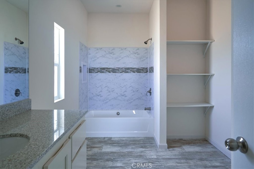 13369 Centola Road Phelan, CA 92371 - Photo 20 of 34 a bathroom with a bathtub and a shower