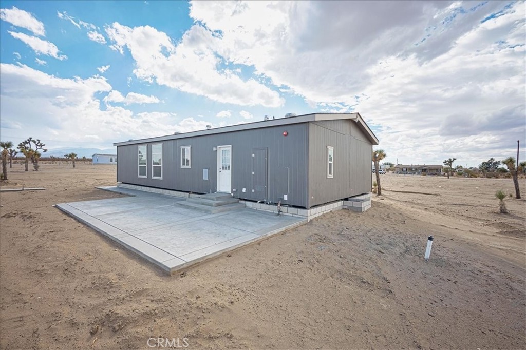 13369 Centola Road Phelan, CA 92371 - Photo 31 of 34 a view of a house with a backyard
