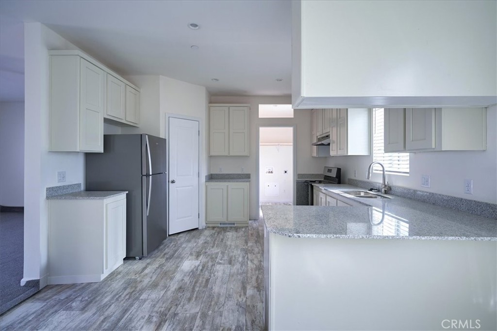 13369 Centola Road Phelan, CA 92371 - Photo 10 of 34 a kitchen with refrigerator and cabinets