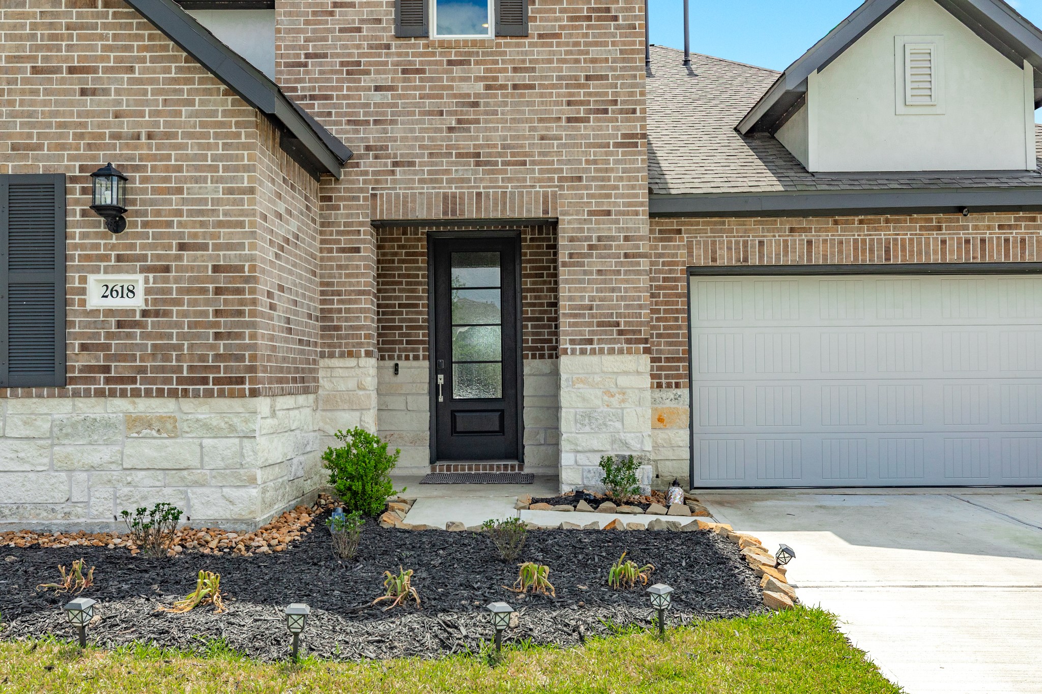 2618 Jasper Oaks Drive Rosharon, TX 77583 - Photo 2 of 43 This home features a stunning wooden and glass front door, creating an inviting exterior. Imagine the warm welcome that awaits inside!