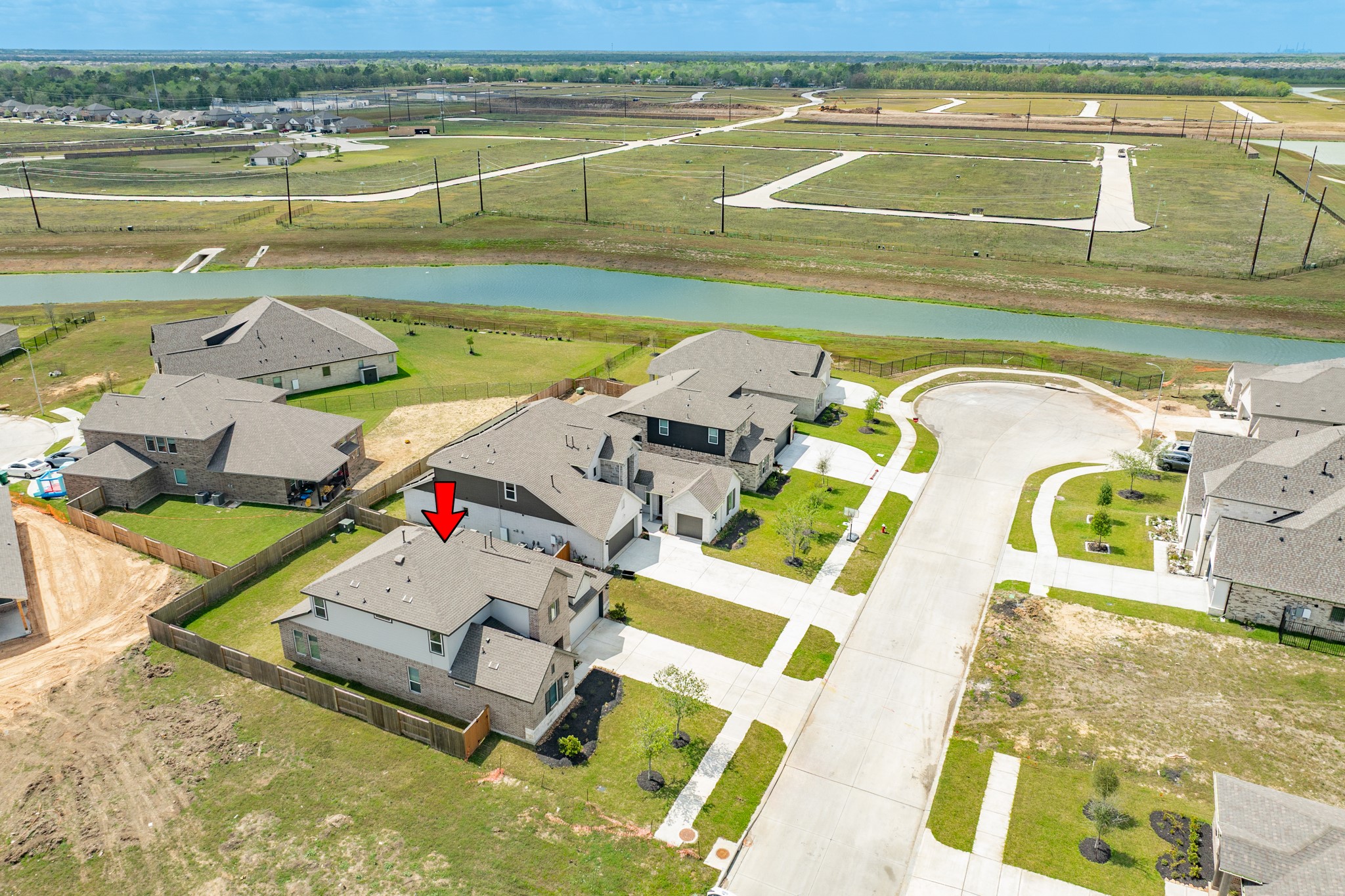 2618 Jasper Oaks Drive Rosharon, TX 77583 - Photo 39 of 43 This aerial view highlights the property's position relative to the pond, offering a clear visual of its surroundings.