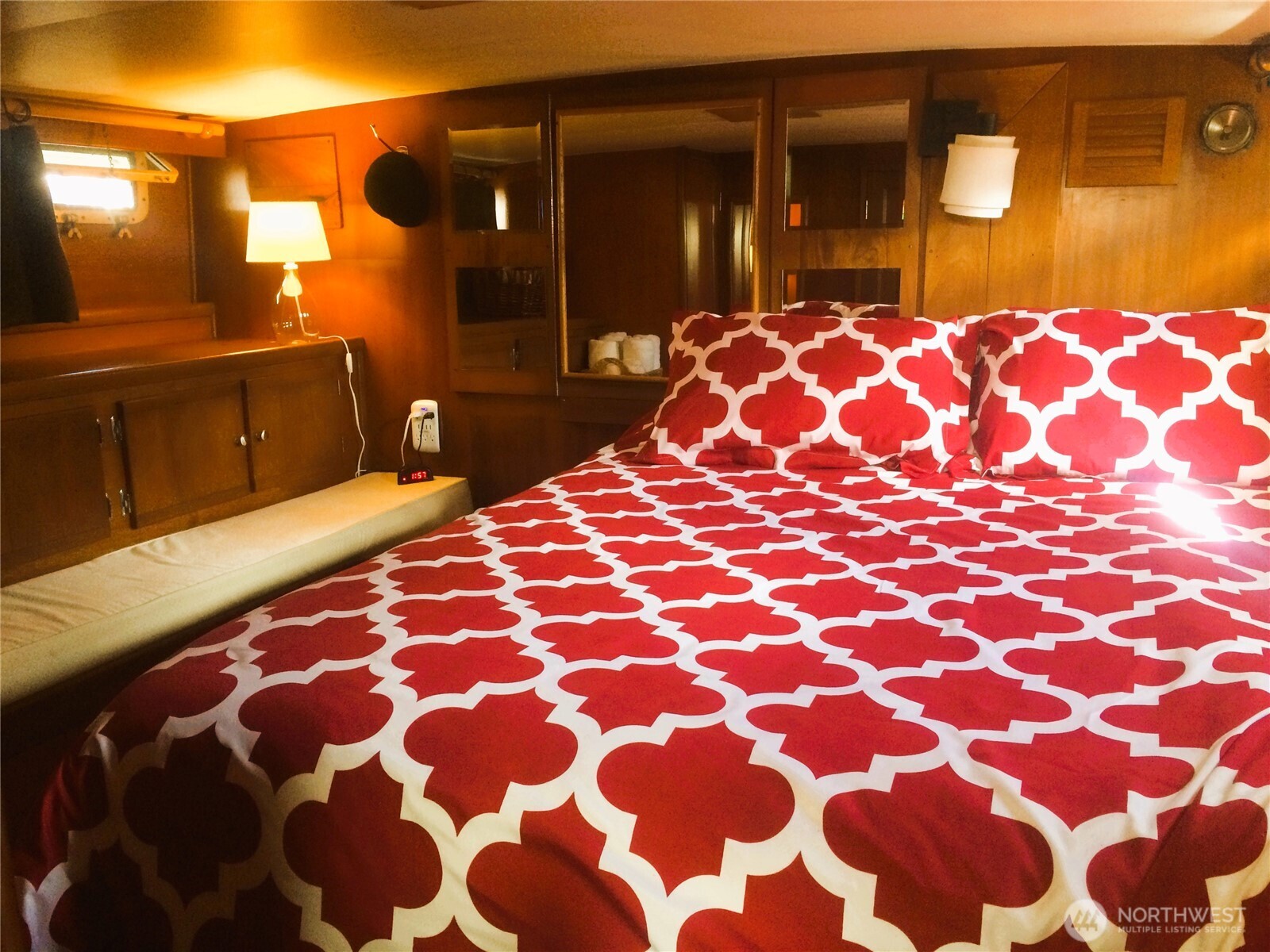 2040 Westlake Avenue North, Unit 10 Seattle, WA 98109 - Photo 12 of 14 a bedroom with a bed and a mirror