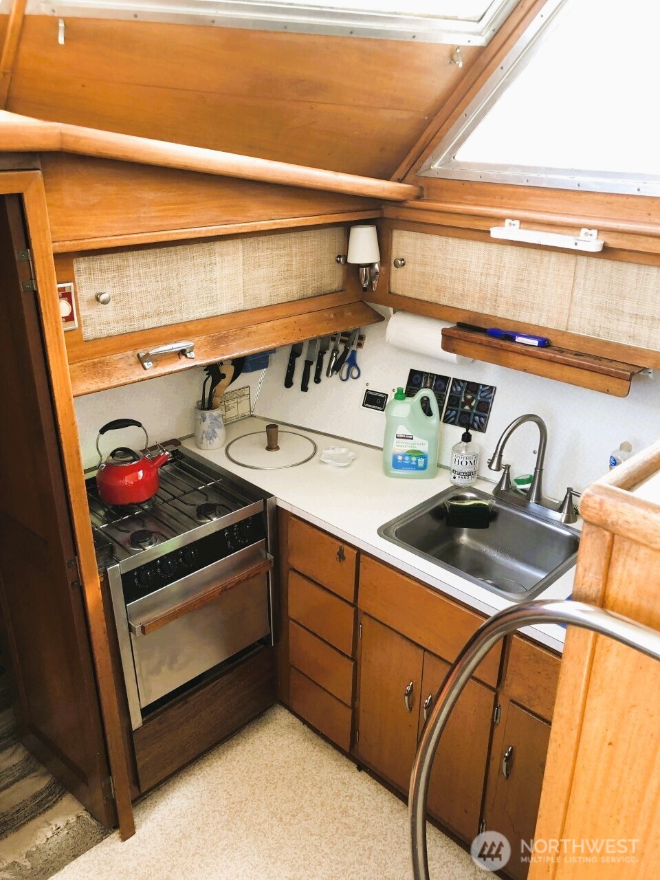 2040 Westlake Avenue North, Unit 10 Seattle, WA 98109 - Photo 5 of 14 a utility room with stainless steel appliances a sink and a stove