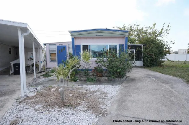 a front view of house with yard and trees around