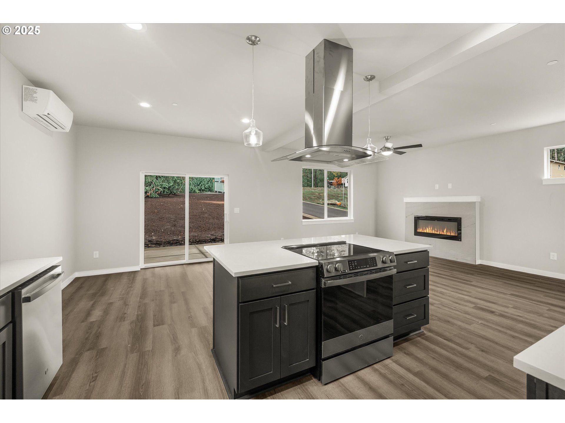 185 Southwest Mawrcrest Avenue Gresham, OR 97030 - Photo 21 of 46 a kitchen with granite countertop a stove a sink and a wooden floors