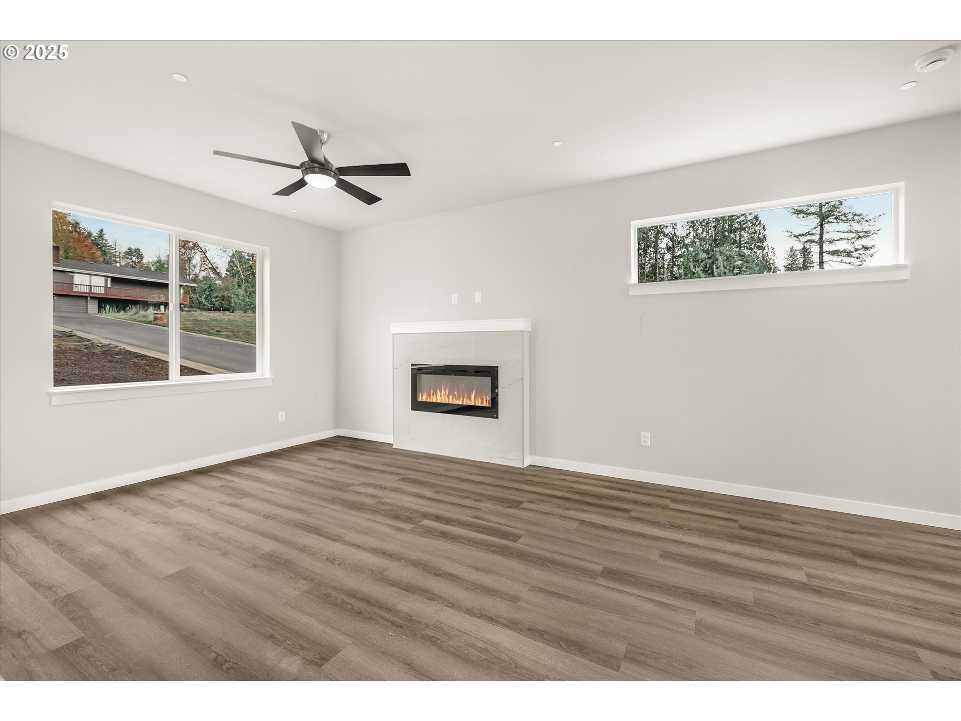 185 Southwest Mawrcrest Avenue Gresham, OR 97030 - Photo 22 of 46 a view of an empty room with a window and wooden floor
