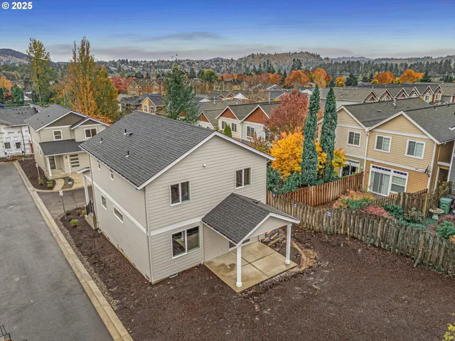 an aerial view of a house with wooden fence