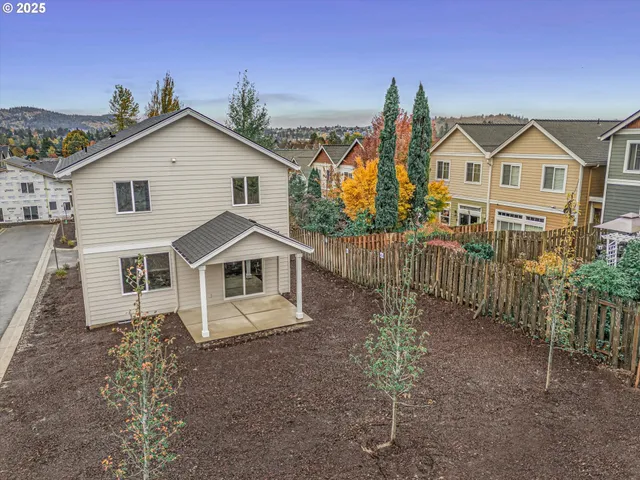 a view of a house with a yard and potted plants