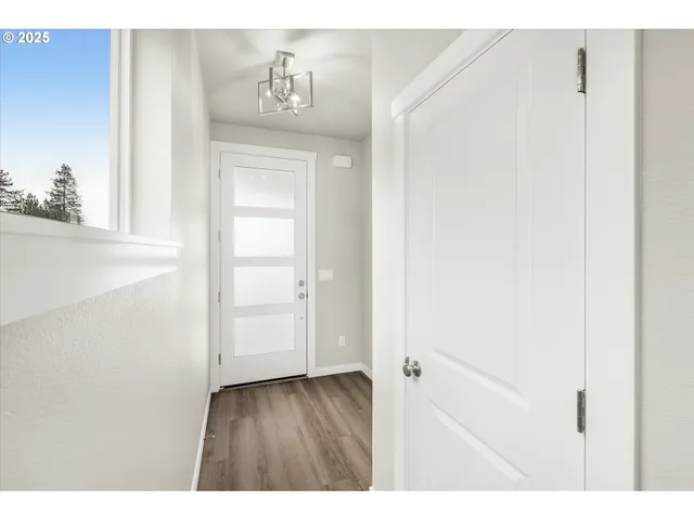 a view of an entryway with wooden floor