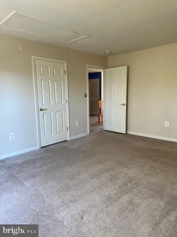 a view of an empty room and closet area