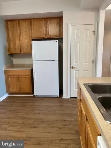 a kitchen with granite countertop a refrigerator and a stove