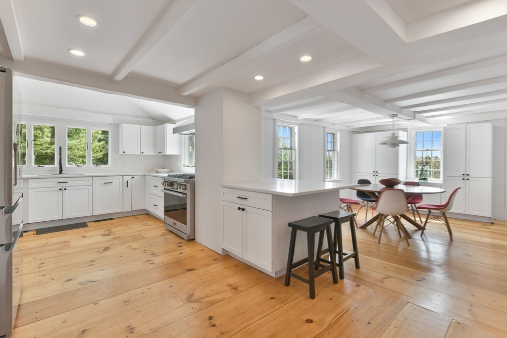 74 Wright Road Ashby, MA 01431 - Photo 8 of 26 a kitchen with white cabinets and chairs