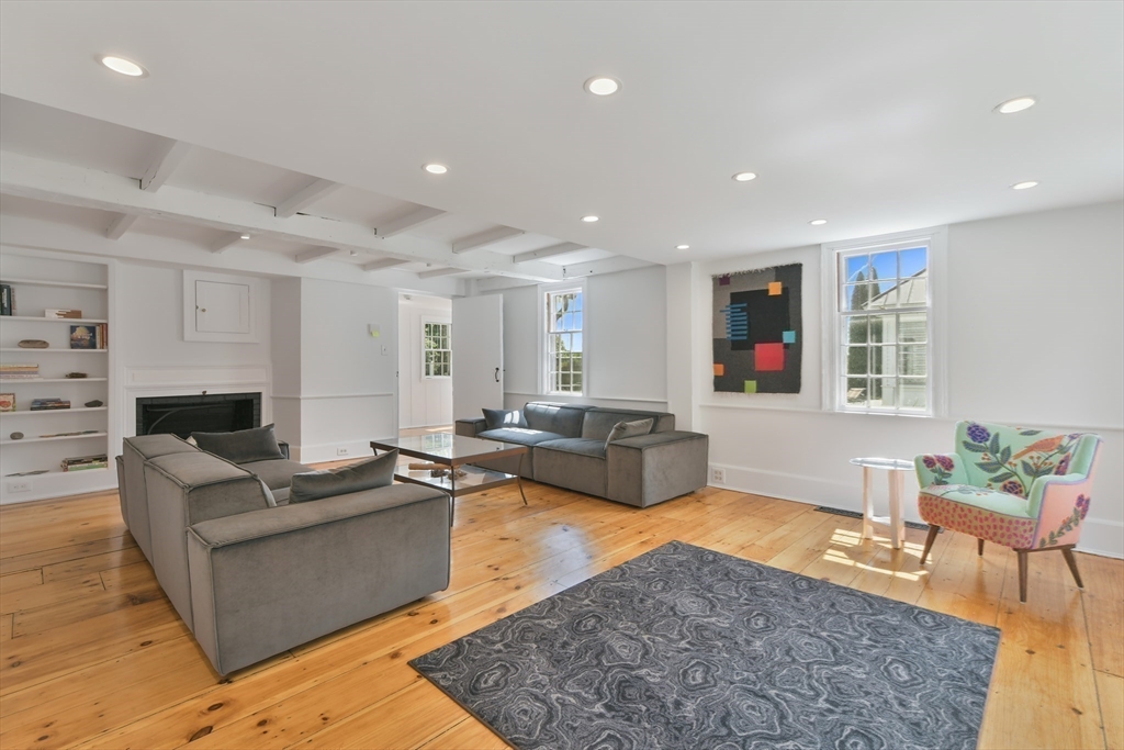 74 Wright Road Ashby, MA 01431 - Photo 9 of 26 a living room with furniture wooden floor and a fireplace