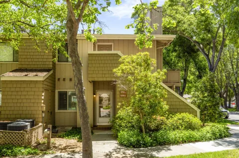 a view of a house with a tree