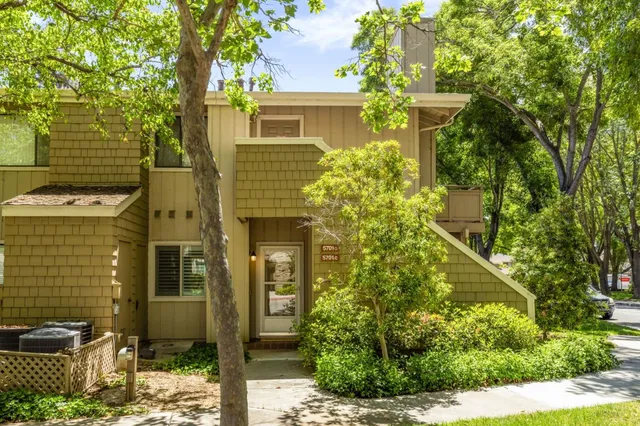 a view of a house with a tree