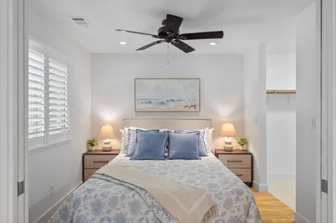 a bedroom with a bed and a painting on the wall