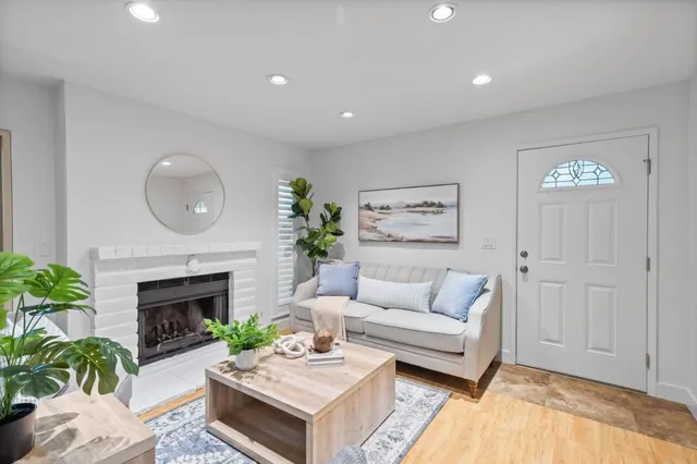 a living room with furniture and a potted plant