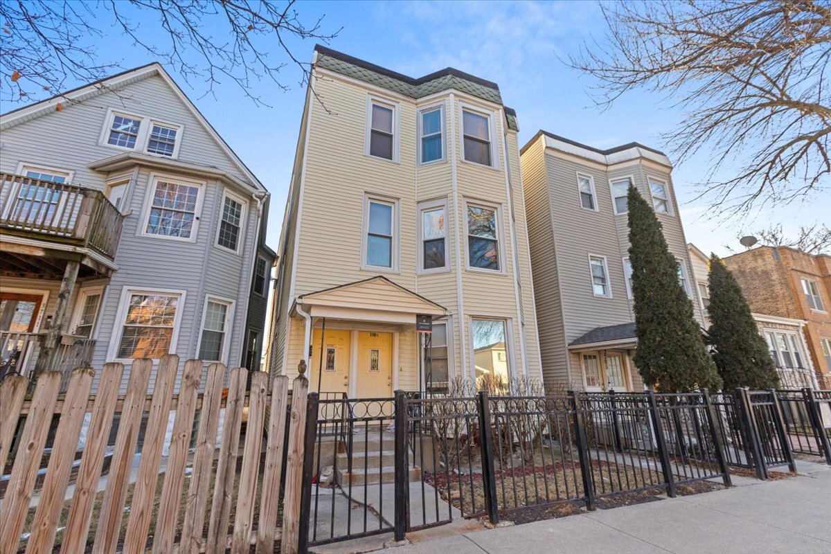 3709 North Troy Street, Unit 1 Chicago, IL 60618 - Photo 1 of 12 a front view of a house with a yard