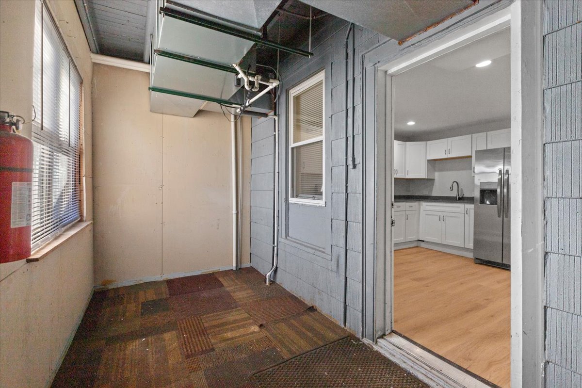 3709 North Troy Street, Unit 1 Chicago, IL 60618 - Photo 12 of 12 a view of a hallway with wooden floor and a kitchen