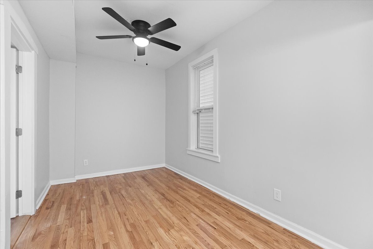 3709 North Troy Street, Unit 1 Chicago, IL 60618 - Photo 3 of 12 an empty room with a window and a ceiling fan