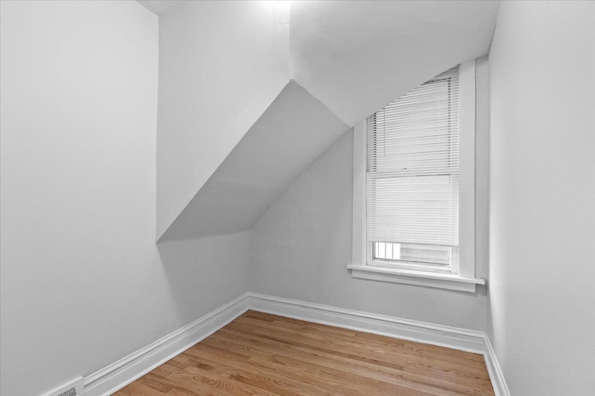 3709 North Troy Street, Unit 1 Chicago, IL 60618 - Photo 9 of 12 a view of a small space with wooden floor and a window